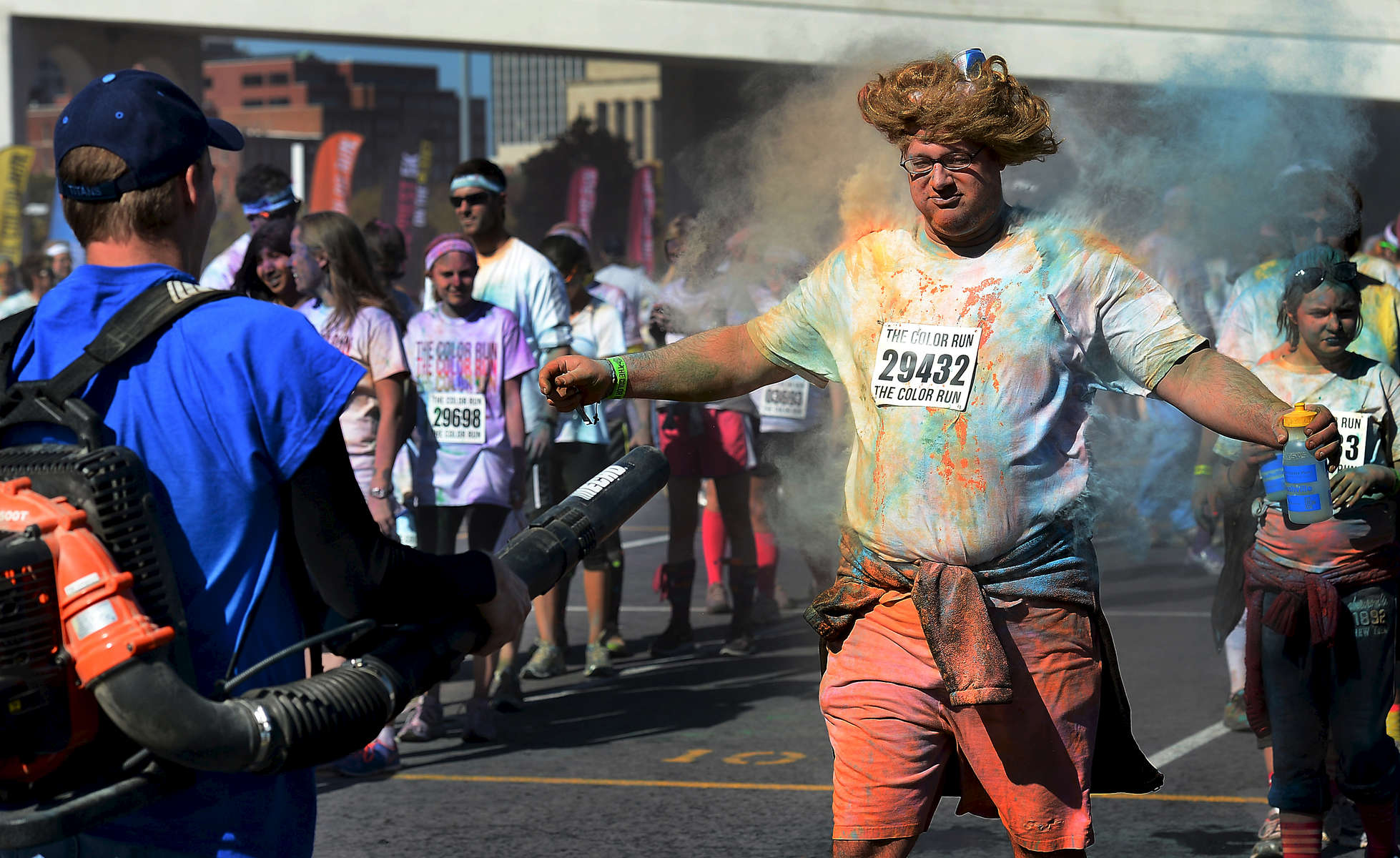 After competing in the 5K Color Run in Nashville, Tenn., participants line up to have the colored dust blown off of them in the festival area. (Mark Zaleski/ For The Tennessean)