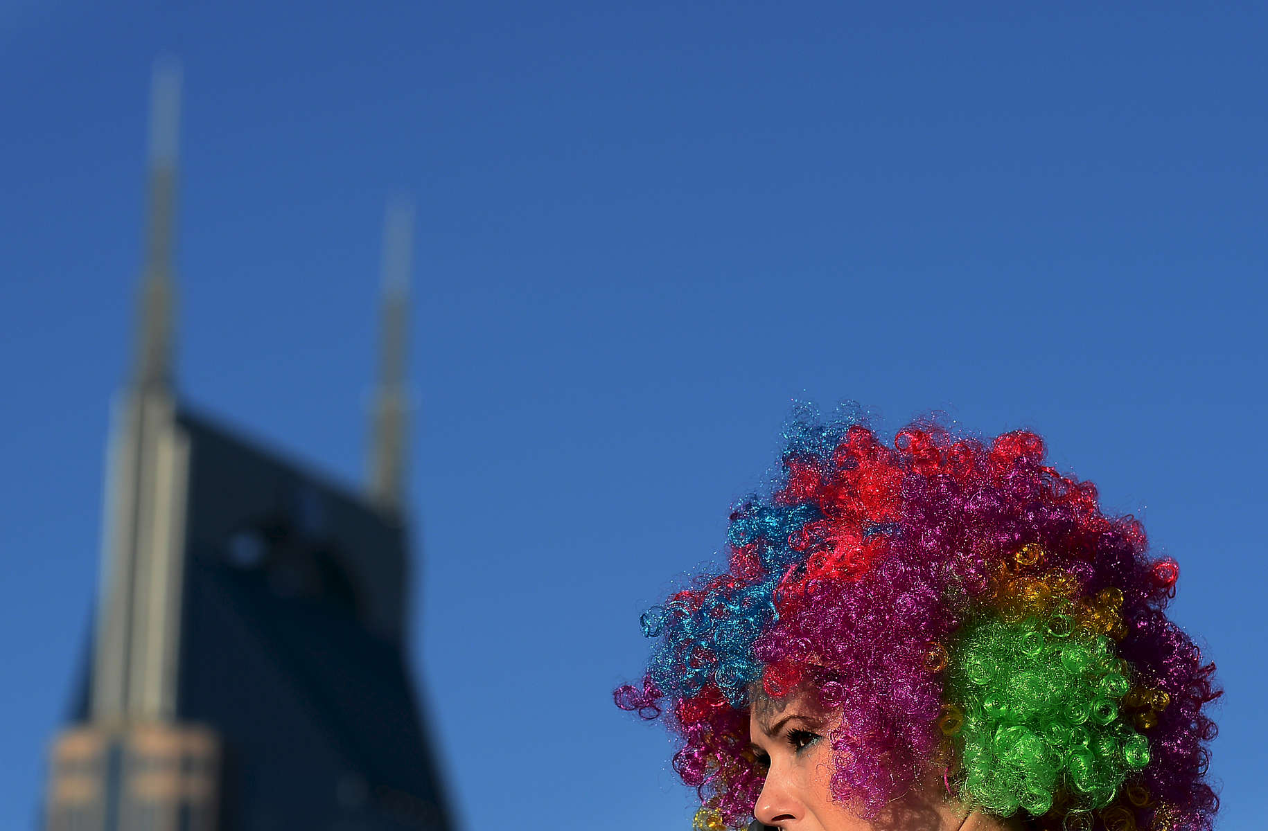 Wearing rainbow wigs and white outfits, a runner prepares to participate in the 5k Color Run near the AT&T building in Nashville, Tenn.(Mark Zaleski/ For The Tennessean)