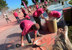 Volunteers shovel pink dust from a barrel to fill spraybottles used to coat runners during the 5K Color Run in Nashville, Tenn. (Mark Zaleski/ For The Tennessean)
