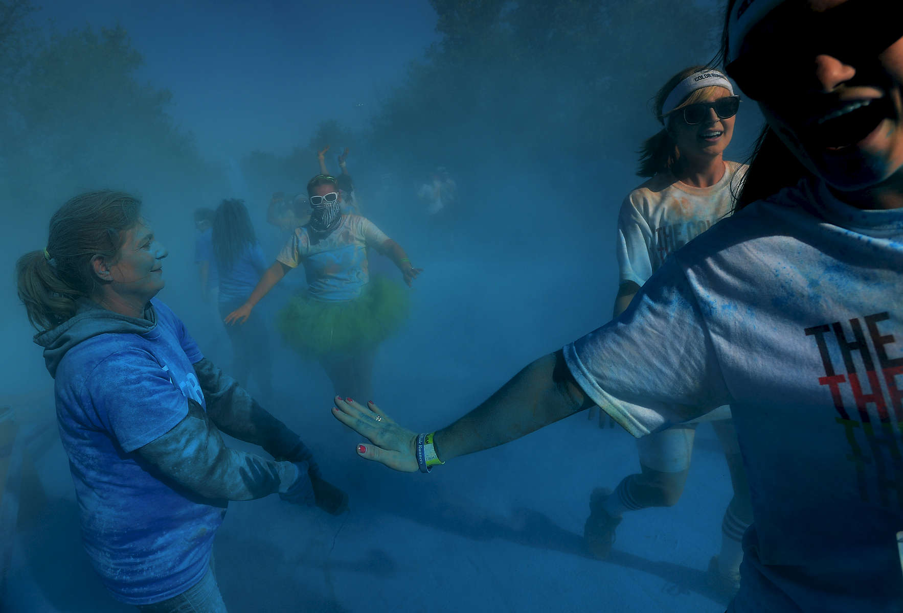 Runners are doused with blue powder by volunteersduring the 5K Color Run in Nashville, Tenn.(Mark Zaleski/ For The Tennessean)