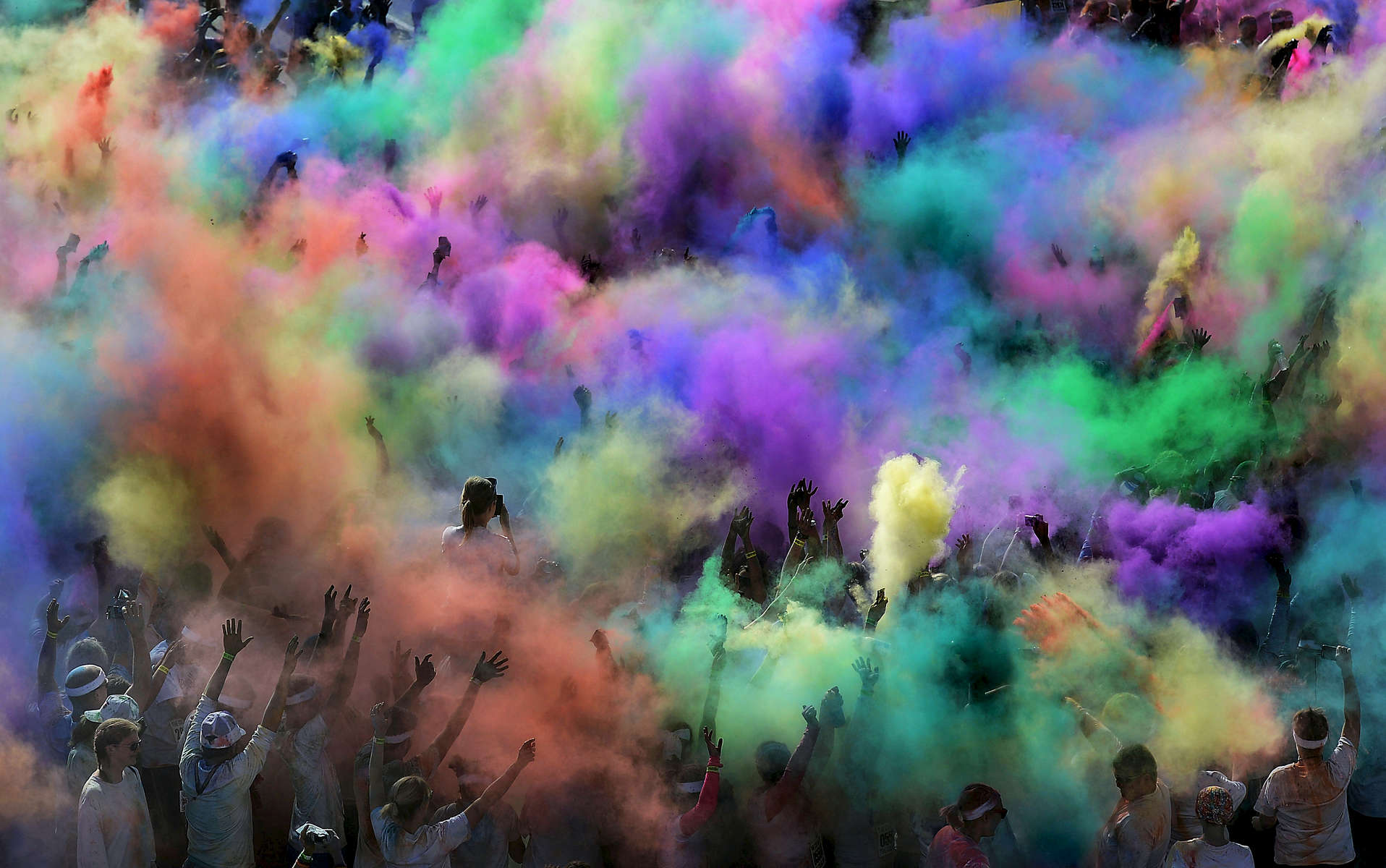 At the end of the 5K Color Run, participants openpackets of colored powder at LP Field in Nashville, Tenn. (Mark Zaleski/ For The Tennessean)
