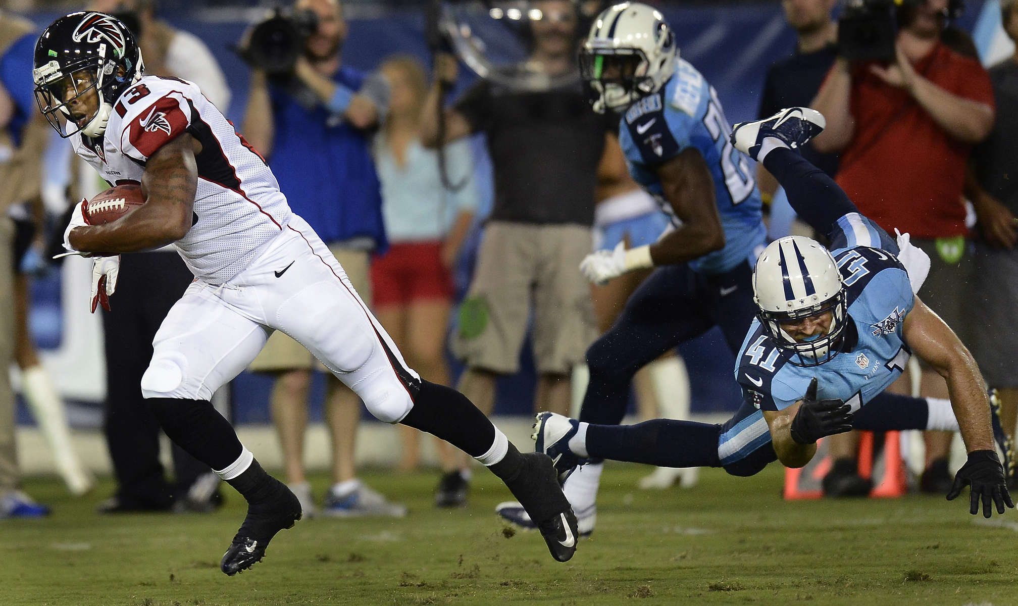 Atlanta Falcons wide receiver Darius Johnson runs theball toward the end zone for a touchdown as Tennessee Titans Corey Lynch misses the tackle during the secondhalf of an NFL preseason football game on Aug. 24, 2013, in Nashville, Tenn. (AP Photo/Mark Zaleski)