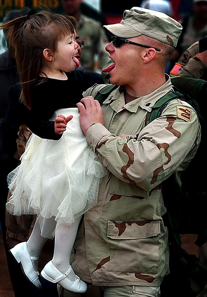 Kevin Halverson of the San Bernardino National Guard 1st Battalion of the 185th Armor Regiment makes silly faces with his daughter, Breanna, duringa welcome home celebration at Arrowhead Credit Union Park in San Bernardino, Calif. Halverson spent a year in Iraq building roads, bridges and dams. (The Press-Enterprise/ Mark Zaleski) 
