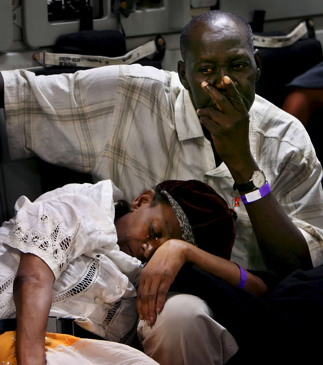 A man comforts his sick wife while in the cargo bay after being evacuated from Port-Au-Prince Haiti.190 evacuees will be flown to Orlando Sanford International  Airport in Fla. to stay with relatives or family members.  (The Press-Enterprise/ Mark Zaleski)