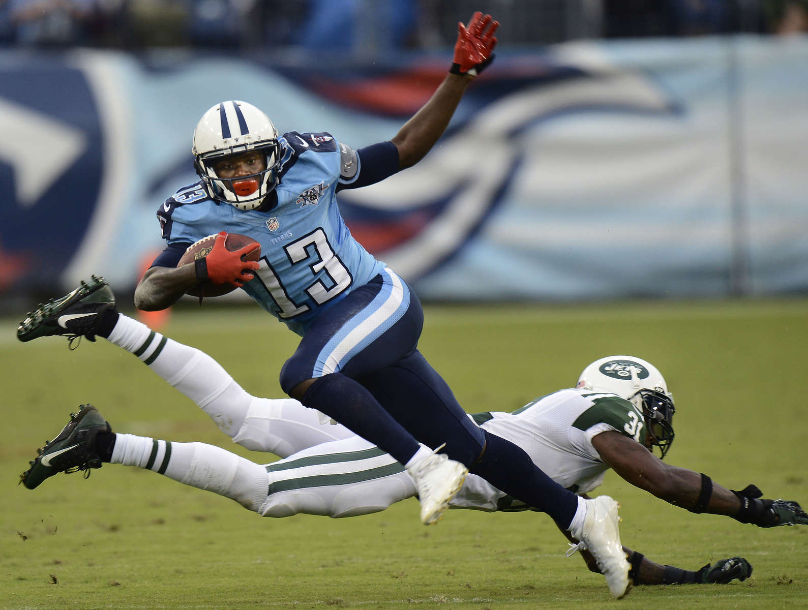 Tennessee Titans wide receiver Kendall Wright gets pastNew York Jets cornerback Antonio Cromartie in the third quarter of an NFL football game on Sept. 29, 2013, in Nashville, Tenn. (AP Photo/ Mark Zaleski)