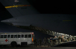 Ground crew members and littler bearers carry wounded warriors into the cargo bay of a March Air Reserve Base Globemaster C-17 aircraft at Bagram Air Force Base in Afghanistan. (The Press-Enterprise/ Mark Zaleski)