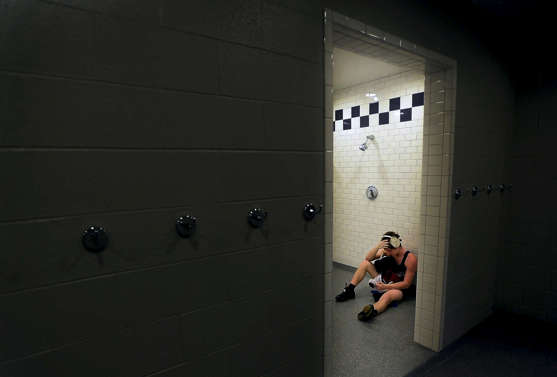 Arie Bekhtyar of Franklin High School spends time alone in the boys shower area after losing his match during the quarterfinals of the 44th annual Father Ryan Invitational Wrestling Tournament in Nashville, Tenn. (Mark Zaleski/ The Tennessean)