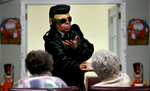 Housekeeper Linda Merim lip syncs Love Me Tender inher Elvis Presley outfit while entertaining residents during the last Christmas party. {quote}I do what I can to make them laugh. It is sad it has to be my last performance for them,{quote} Merim said, before the pending closing of the retirement home. (The Press-Enterprise/ Mark Zaleski)