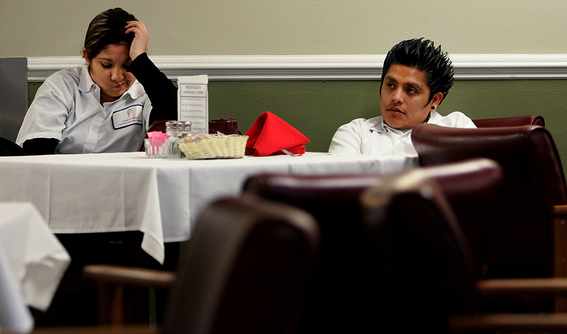 Food server Raynette Esquivel, left, and dishwasher Vicente Vaguax wait to serve dinner to the residents in the dining room after being informed that the Plymouth Tower will be closing. (The Press-Enterprise/ Mark Zaleski)