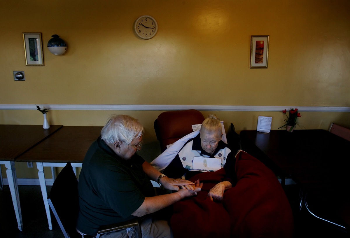 Leon May, 90, spends time massaging the handsof his wife, Maddy, 87, in the bingo room. Thecouple have yet to find a suitable facility to live.(The Press-Enterprise/ Mark Zaleski)