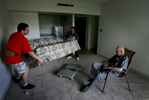 Sy Archer, 94, sits in his patio chair while watching Ben Chambers, left, of It's On It's Way home delivery service move his couch out of the apartment on the Independent living floor. Sy and his wife Joy found a place to live at the Olivegrove Retirement facility in Riverside. {quote}We were planning on dying here,{quote} said Joy Archer, who watched from the hallway during themove. (The Press-Enterprise/ Mark Zaleski)