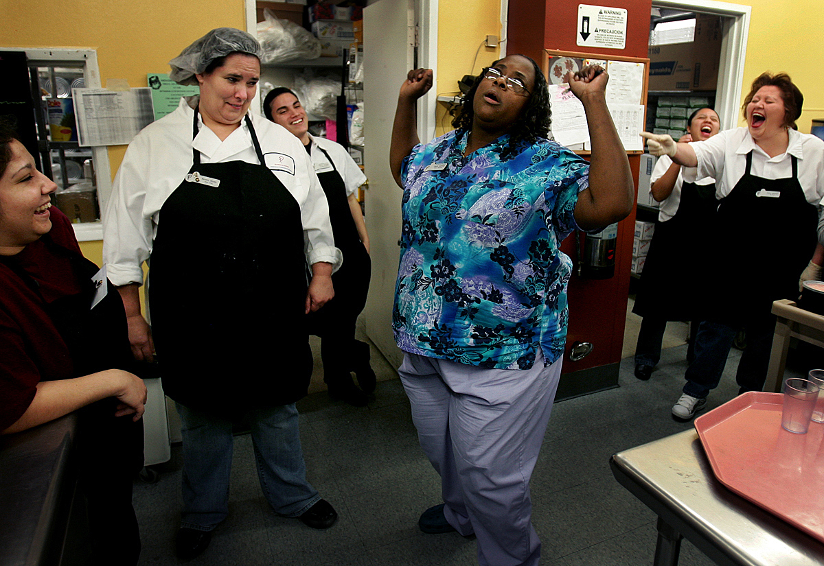 Head cook Beverly Snyder, second from left, watches dietary supervisor Claudia Cummings, center, make fun of her dancing as they prepare for the last employee and resident Christmas party.(The Press-Enterprise/ Mark Zaleski)