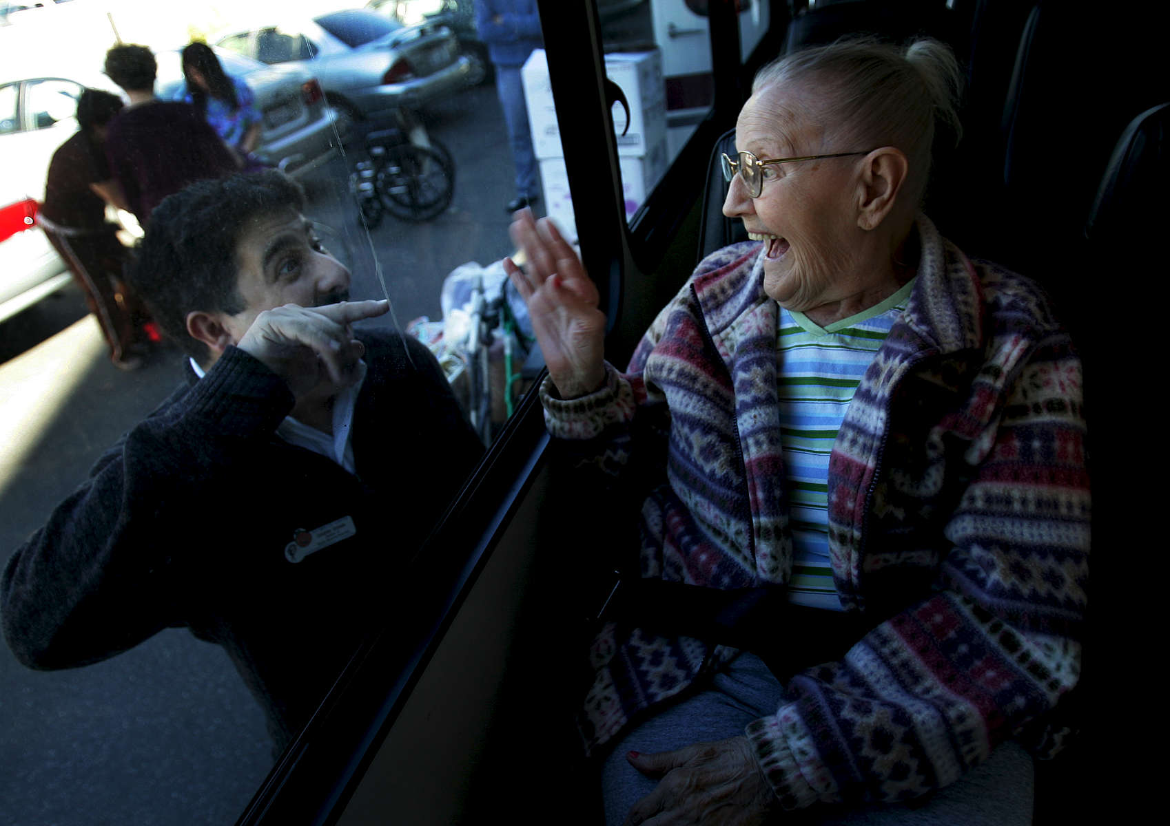 Activity and Social Services Director Edoardo Estradamakes resident Helen Bodo, 91, laugh before Bodo travels to her new home at Bixby Knolls Towers Retirement Residence in Long Beach, Calif. Bodo had lived at Plymouth Towers for over 10 years. (The Press-Enterprise/ Mark Zaleski)