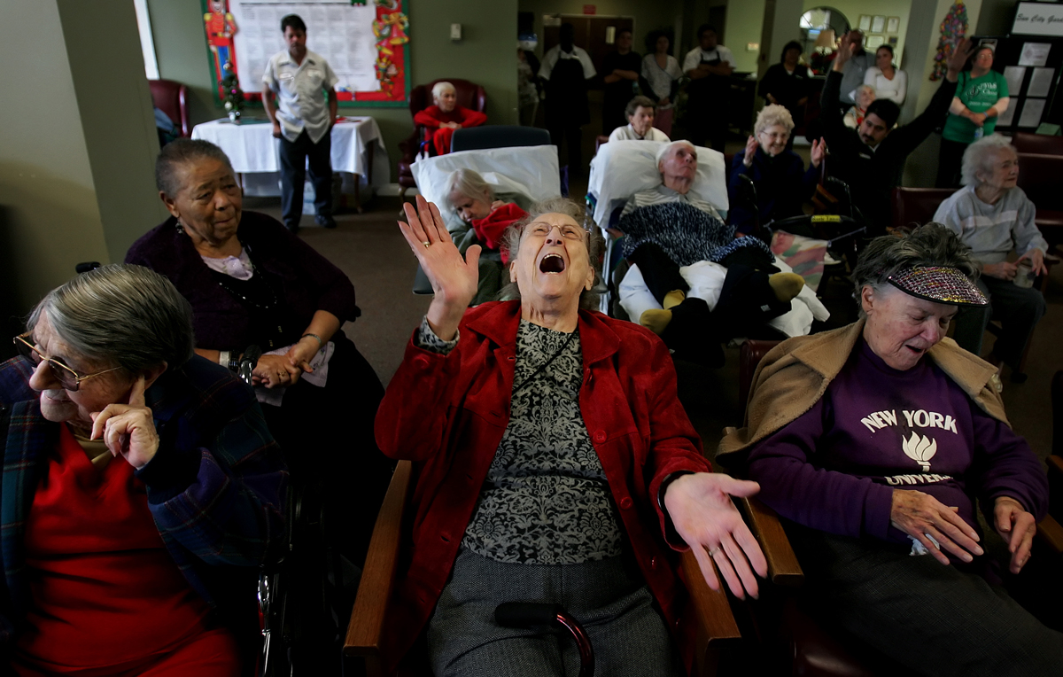 Resident Lula Allison, 95, center, shouts for more Chirstmas songs while applauding the Jurupa Middle School Choir's performance at Plymouth Tower. (The Press-Enterprise/ Mark Zaleski)