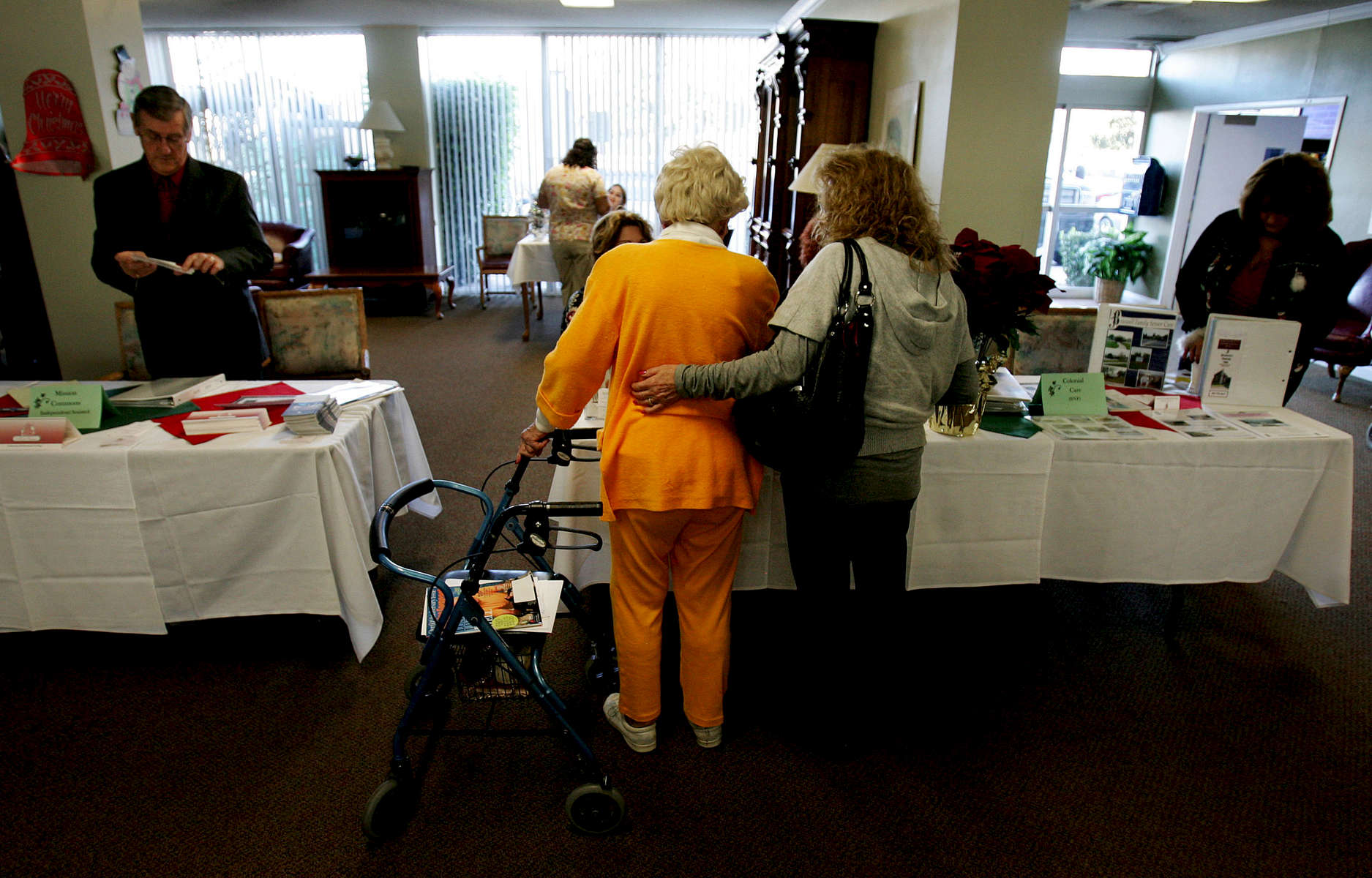 Paula Hanisee, right, helps her mother-in-law, June Taliaferro, 85, look at other possible residential nursing facilities in the region during a residentconference orginized by the Pylmouth Tower. (The Press-Enterprise/ Mark Zaleski)