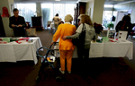 Paula Hanisee, right, helps her mother-in-law, June Taliaferro, 85, look at other possible residential nursing facilities in the region during a residentconference orginized by the Pylmouth Tower. (The Press-Enterprise/ Mark Zaleski)
