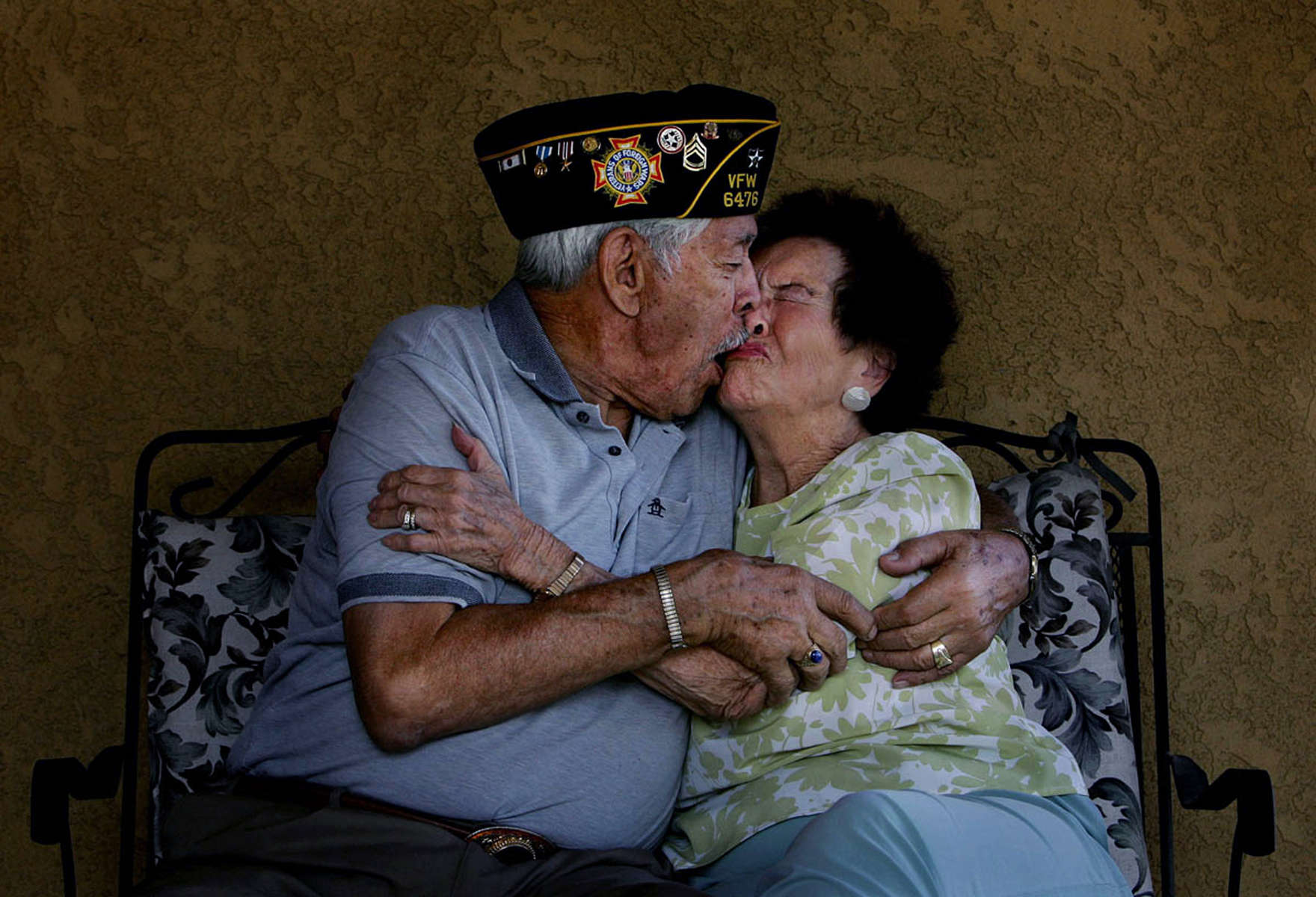 U.S. Coast Guard veteran Fred Cordova, 85, kisses his wife, Angelina, 82, while playfully joking around at their home in Colton, Calif. (The Press-Enterprise/ Mark Zaleski)