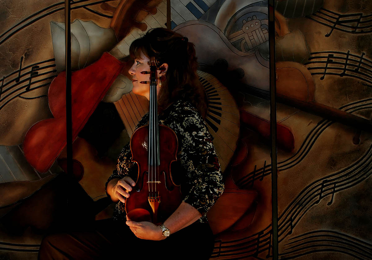 Jeanne Skrocki of Corona, Calif., has been a violinist for the Pacific Symphony Orchestra in Orange County, Calif., for 15 years. The 1747 J.B. Guadagnini violin Skrocki holds was handed down to her from her mother. (The Press-Enterprise/ Mark Zaleski)
