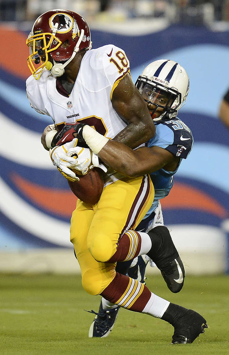 Washington Redskins Lance Lewis is tackled by Tennessee Titans Khalid Wooten in the fourth quarter in a preseason NFL football game against the Tennessee Titans on Aug. 8, 2013, in Nashville, Tenn. (AP Photo/ Mark Zaleski)
