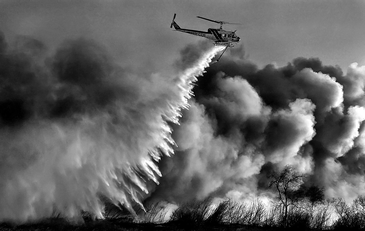 First place photograph in the World Press Photo Foundation's nature category, 2004. A California Department of Forestry helicopter drops water on a fire burning in the Santa Ana River bed in Mira Loma, Calif. (The Press-Enterprise/ Mark Zaleski)