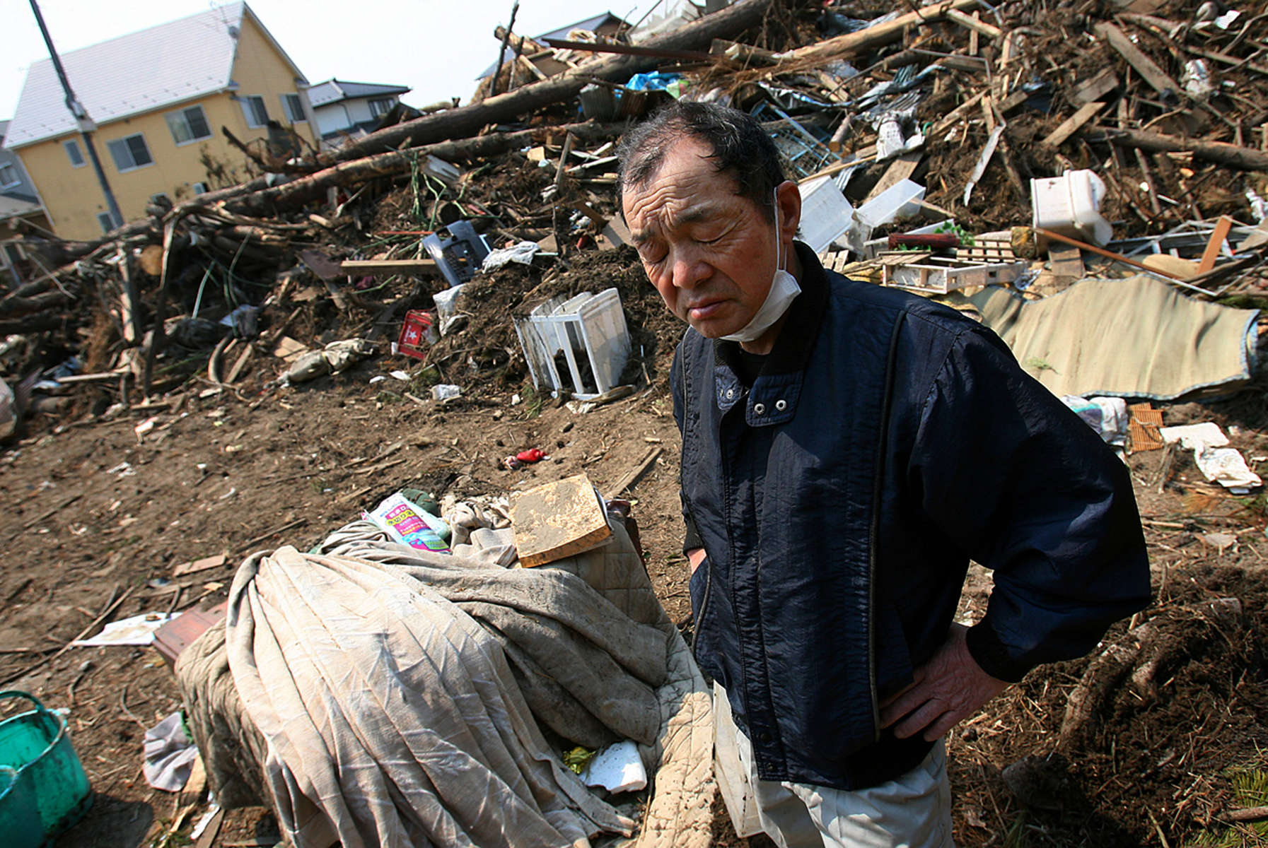 Ichio Hirayama pauses while trying to salvage any personal belongings from his home that was destroyed when the massive tsunami hit Sendai, Japan. (The Press-Enterprise/ Mark Zaleski) 