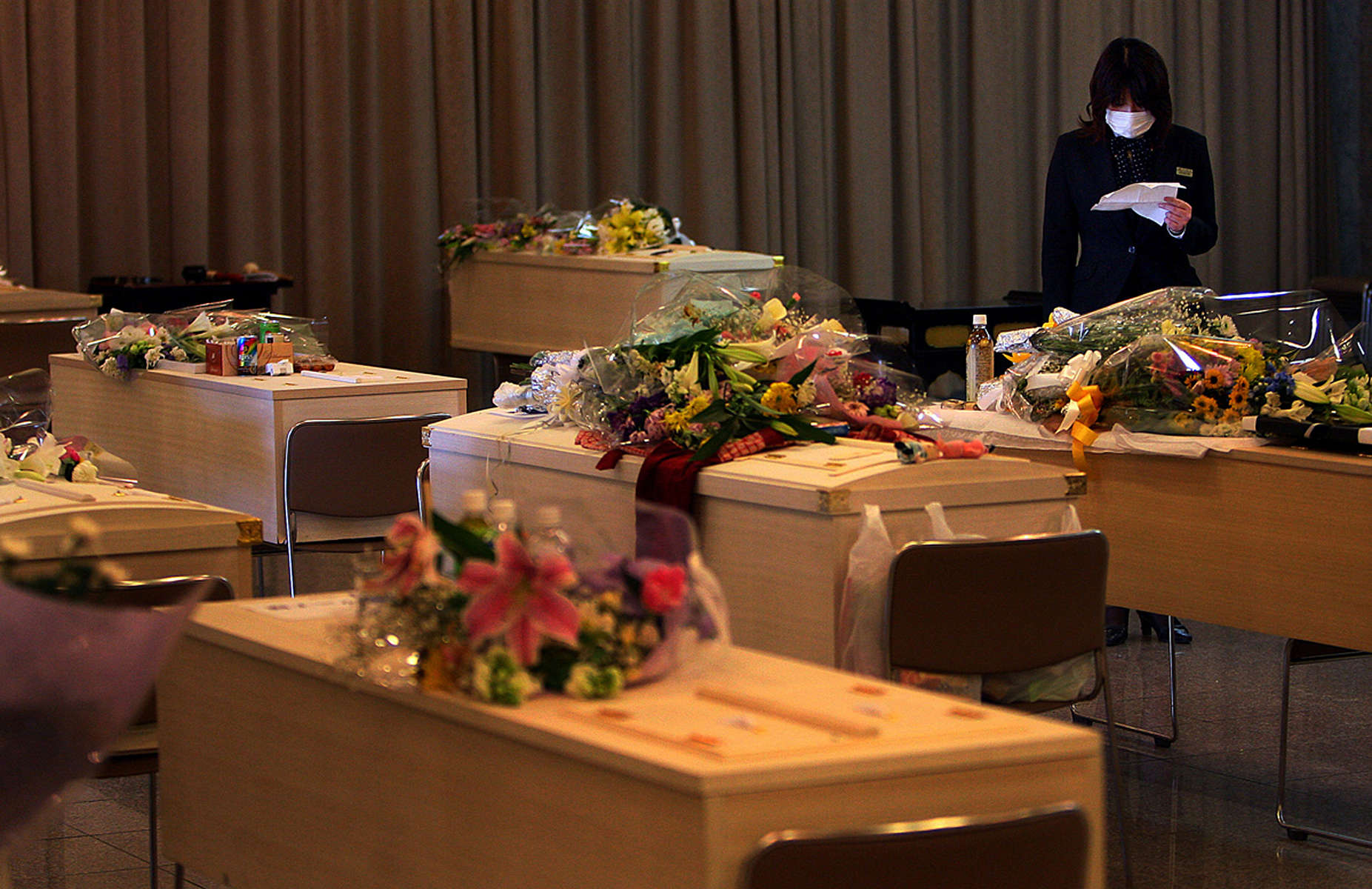 A Berko Natori funeral home assistant checks the funeral schedule sheet listing victims of the massive earthquake and tsunami that hit Sendai, in the Miyagi Prefecture of northern Japan. (The Press-Enterprise/ Mark Zaleski)