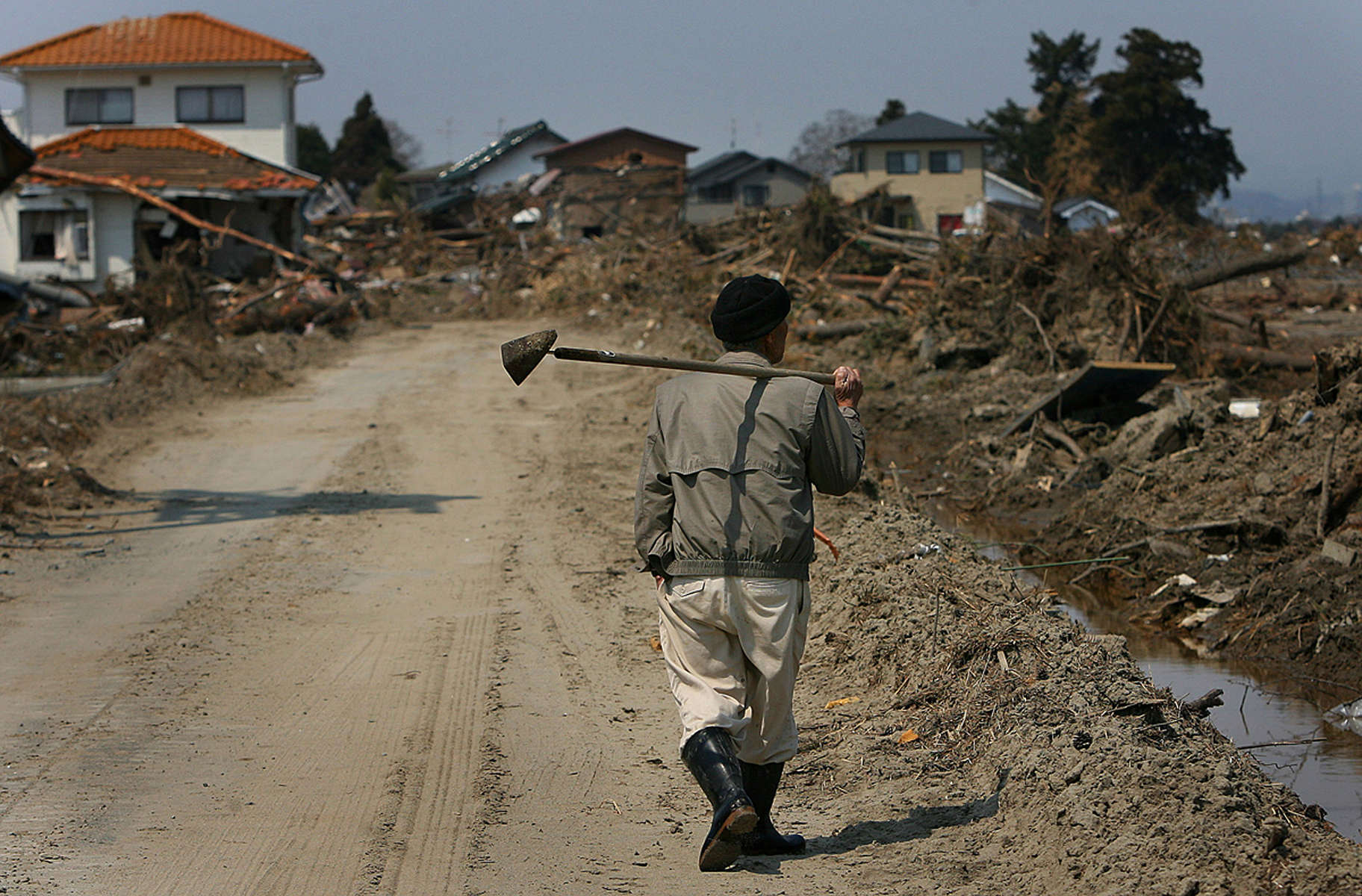 A man walks through the debris in his neighborhood in Sendai, in the Miyagi Prefecture of northern Japan. (The Press-Enterprise/ Mark Zaleski)