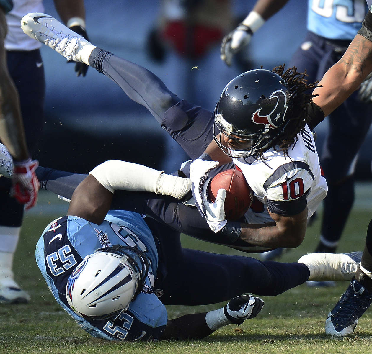 Houston Texans wide receiver DeAndre Hopkinsis brought down by Tennessee Titans linebacker Moise Fokou in the fourth quarter of an NFL football game on Dec. 29, 2013, in Nashville, Tenn. (AP Photo/ Mark Zaleski)