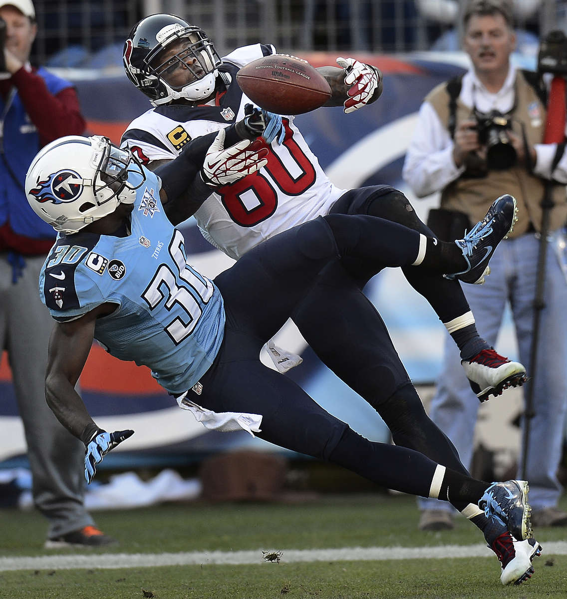 Tennessee Titans cornerback Jason McCourty breaksup a pass intended for Houston Texans wide receiver Andre Johnson in the fourth quarter of an NFL football game on Dec. 29, 2013, in Nashville, Tenn. (AP Photo/Mark Zaleski)