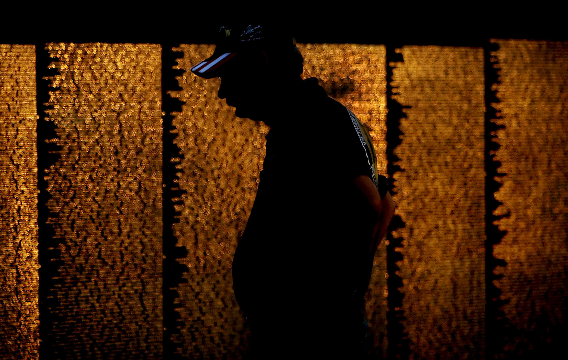 Riverside resident Steve Mackey, 57, president of the Vietnam Veterans of America Chapter 47 of the InlandEmpire, admires the names on the Vietnam Veterans Memorial Moving Wall at Sylvan Park in Redlands, Calif., at dust Mackey of the United States Army served in Vietnam in 1970. (The Press-Enterprise/ Mark Zaleski)