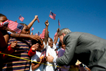 President Bush: Visit to Waldo C. Falkener Elelmentary School. Greensboro, North Carolina. Students wave American flags.President George W. Bush greets flag-waving students at the Waldo C. Falkener Elementary School Wednesday, Oct. 18, 2006, in Greensboro, N.C., where he delivered remarks on the No Child Left Behind Act. White House photo by Paul Morse  POW