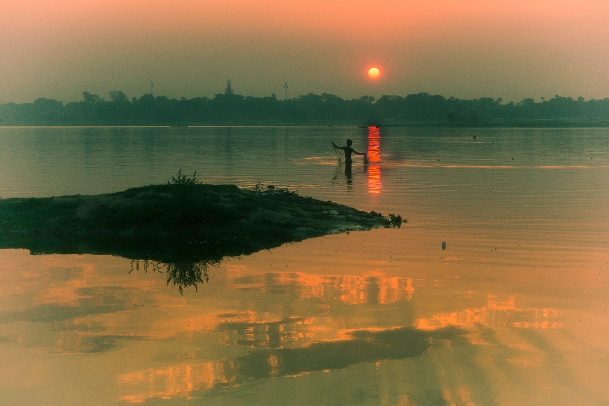 Net fisherman at sunrise