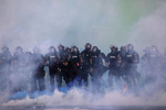 Police officers are seen advancing through tear gas and smoke grenades after they cleared an intersection of mostly seated protesters who were out for George Floyd after curfew was broken in Minneapolis, Minnesota, U.S. May 30, 2020. 