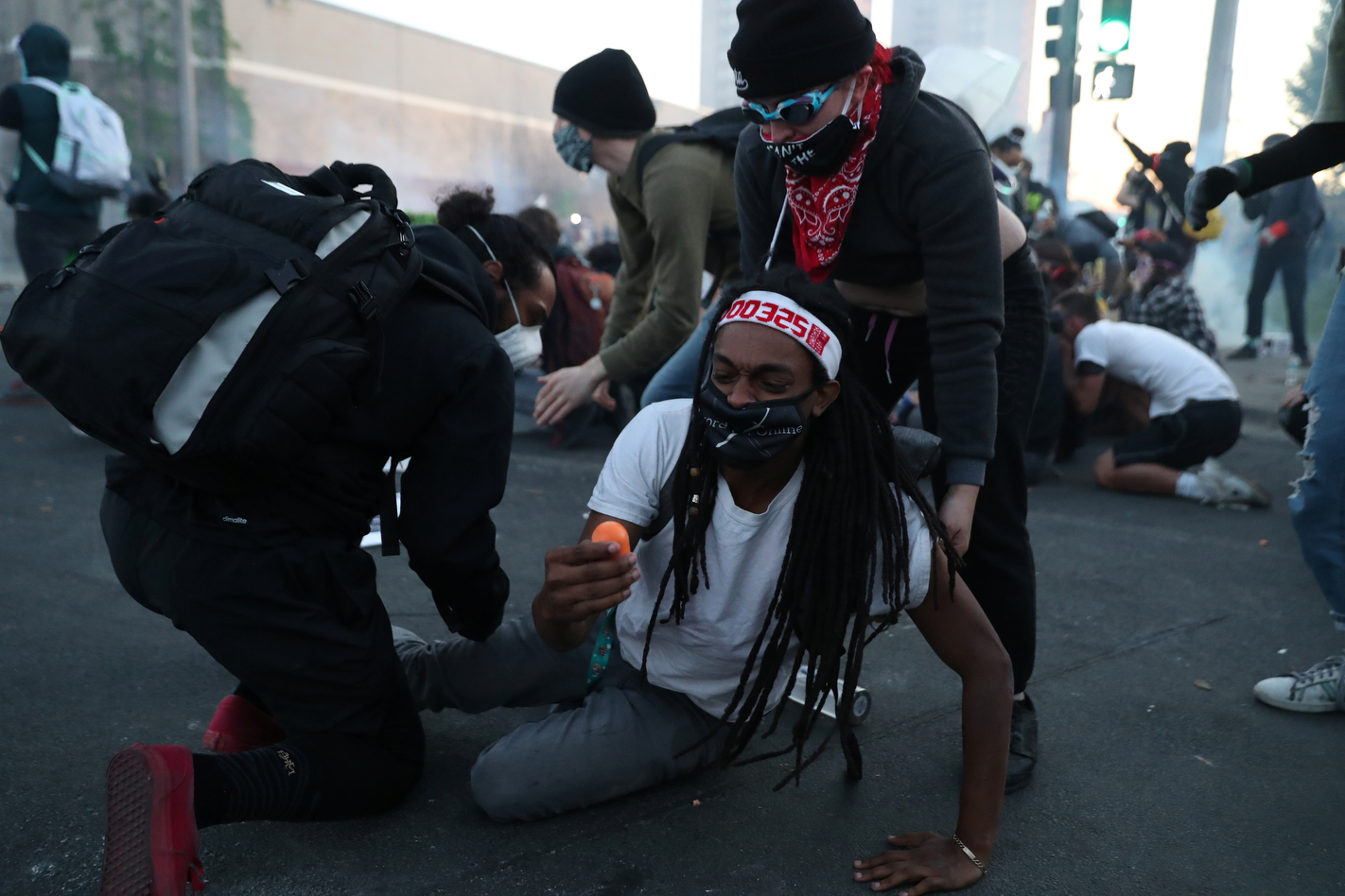 An injured protester looks at a projectile fired by police after police cleared an intersection with teargas and munitions of mostly seated protesters who were out for George Floyd after curfew was broken in Minneapolis, Minnesota, U.S. May 30, 2020. 