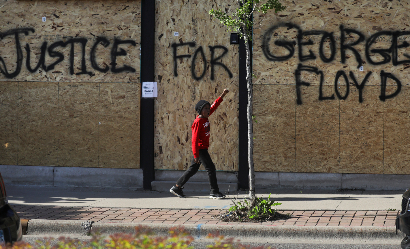 A young man gestures as he walks along the side of the protesters during a rally against the death in Minneapolis police custody of George Floyd, in Saint Paul, Minnesota, U.S. May 31, 2020.  REUTERS/Leah Millis