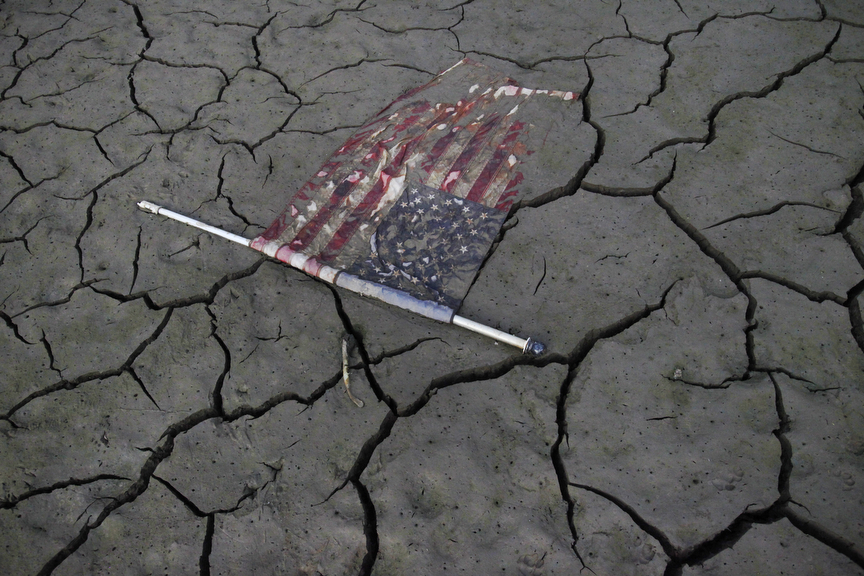 An American flag lays perfectly flat on the freshly exposed bottom of Lake McClure as it sits at about 8 percent capacity Sept 28, 2014 in Snelling, Calif. 