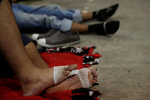 Migrants, part of a caravan traveling to the U.S., rest with bandaged feet in a gym after arriving in Mapastepec, Mexico.