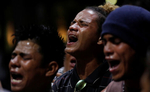 Jose Antonio Perdomo Zuniga of Honduras, sings and prays with other migrants from a caravan he is part of who are traveling to the U.S. while they rest in the Central Park of Miguel Hidalgo in Tapachula, Mexico. 