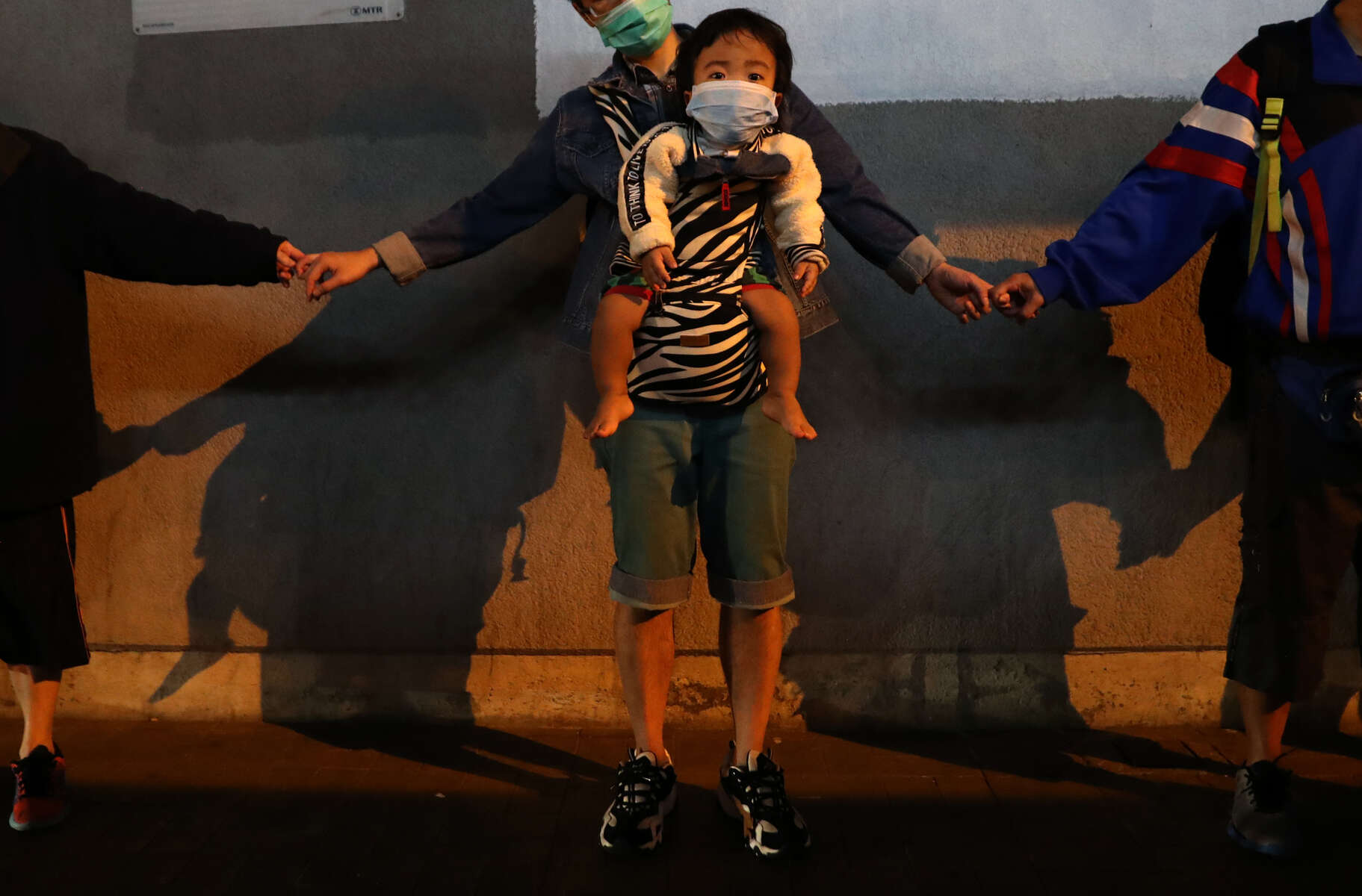 Anti-government protesters hold hands to form a human chain at Kowloon Bay in Hong Kong, China, November 30, 2019. Picture taken November 30, 2019. 