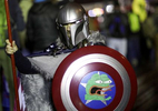 A supporter of U.S. President Donald Trump poses for a photograph in a costume featuring a meme on his shield that is often used in far right and white nationalist communities online during a rally ahead of the U.S. Congress certification of the November 2020 election results during protests in Washington, U.S., January 5, 2021. 