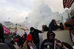 A mob of people, many of whom are supporters of U.S. President Donald Trump, react as they are tear gassed by police officers after they broke through a police line guarding the U.S. Capitol building as the U.S. Congress certification of the November 2020 election results were scheduled to take place inside in Washington, U.S., January 6, 2021.