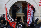 A person breaks a window of the U.S. Capitol building as a mob, many of whom are supporters of U.S. President Donald Trump, attacks the U.S. Capitol building as the U.S. Congress certification of the November 2020 election results were scheduled to take place inside in Washington, U.S., January 6, 2021.