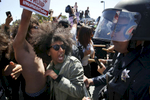 Biseat Yawkal, an Oakland protester, yells as she is pushed by police trying to push protesters back outside of the Hyatt Regency during the first day of the California Republican Party Convention in Burlingame, Calif., Thursday, April 29, 2016. The convention featured speeches from Presidential candidates Donald Trump and John Kasich among others. 