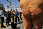 People crowd around a nude statue of Republican Presidential Nominee Donald J. Trump to take photographs of it on Market and Castro streets August 18, 2016 in San Francisco, Calif. Written at the feet of the statue says {quote}the emperor has no balls{quote} -Indecline