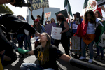 Melissa Crosby gets a drink of water from another protester after chaining herself with other protesters to block off access roads outside of the Hyatt Regency during the first day of the California Republican Party Convention which featured speeches from Presidential candidates Donald Trump and John Kasich among others April 29, 2016 in Burlingame, Calif.