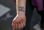 Christopher Ray of San Francisco shows off his Bernie Sanders tattoo during a Hillary Clinton fundraising protest in Nob Hill April 15, 2016 in San Francisco, Calif. The fundraiser was attended by George Clooney, among others. Dozens of protesters showed up and marched around the block to each entrance where police had set up barricades.