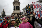 Elsy Tobar, front left, and Kathleen Holton, front right, stand with thousands of others and listen to speakers during a rally in Civic Center Plaza before the Women's March Jan. 21, 2017 in San Francisco, Calif. Thousands gathered in San Francisco to march in solidarity with the Women's March on Washington D.C. to protest the presidency of Donald J. Trump and to rally for the rights of all races, classes and gender identities.