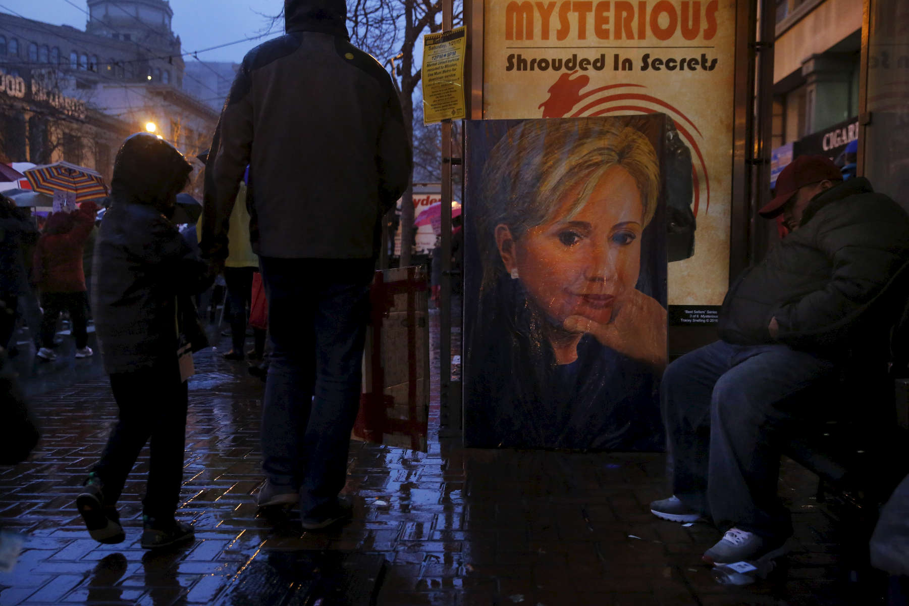 A portrait of Hillary Clinton sits at a bus stop as protesters stream past on Market street during the Women's March Jan. 21, 2017 in San Francisco, Calif. Thousands gathered in San Francisco to march in solidarity with the Women's March on Washington D.C. to protest the presidency of Donald J. Trump and to rally for the rights of all races, classes and gender identities.