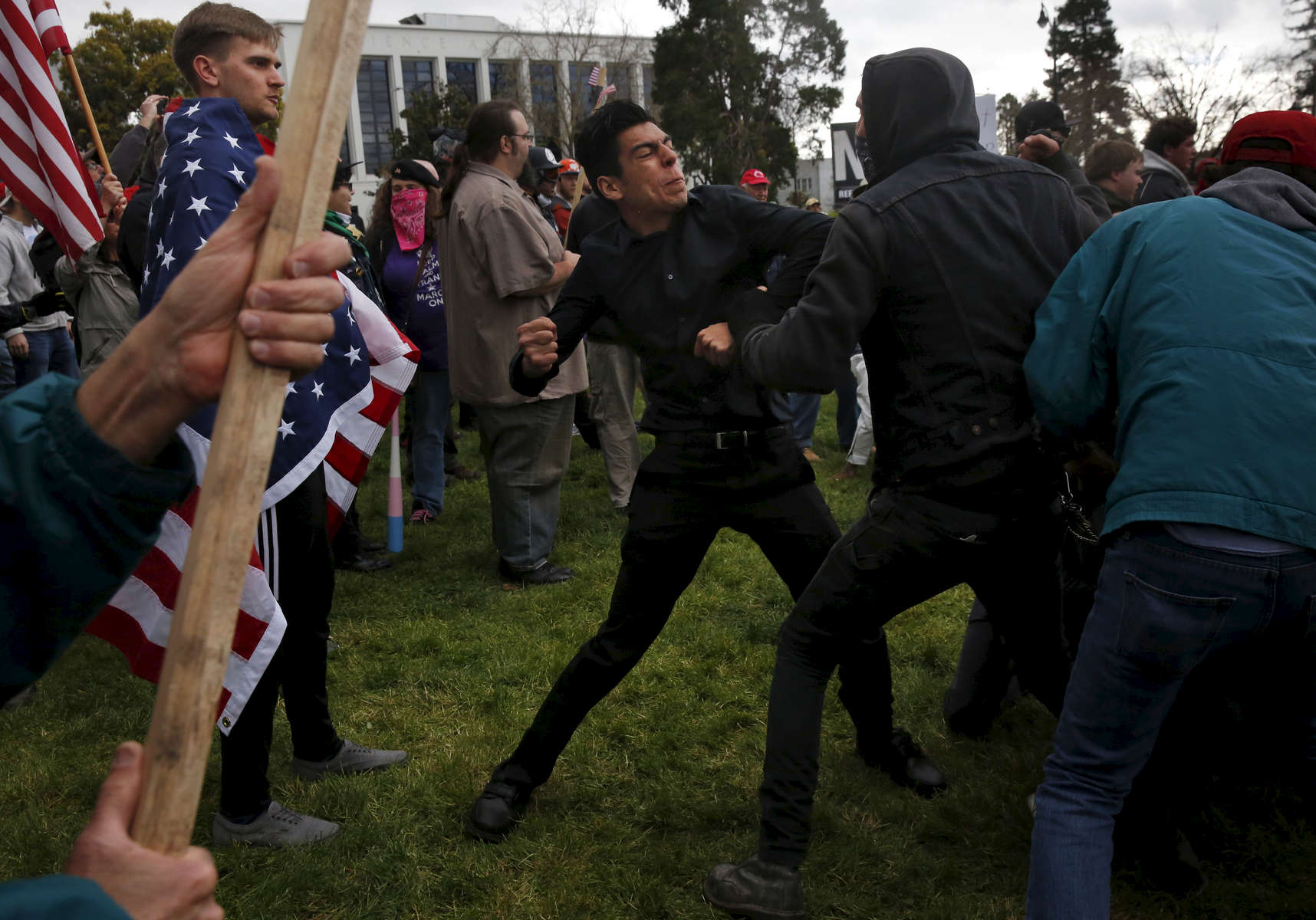 A Trump supporter who preferred not to give his name trades blows with a masked anti-fascist protester during a pro-President Donald Trump rally and march at the Martin Luther King Jr. Civic Center park March 4, 2017 in Berkeley, Calif. 
