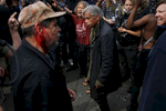 A pro-Trump supporter, left, stands with his fellow supporters and exchange words with anti-fascist protesters, right, after a skirmish on Center and Shattuck streets after a rally called {quote}Patriot's Day Free Speech Rally{quote} in Martin Luther King Jr. Civic Center Park became violent  April 15, 2017 in Berkeley, Calif.